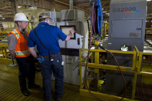 Employees at Roseburg Forest Product’s Riddle plywood plant program a machine at the mill. Engineers and millwrights often use technology in sawmills that requires workers who are highly skilled and trained, but not necessarily college graduates.